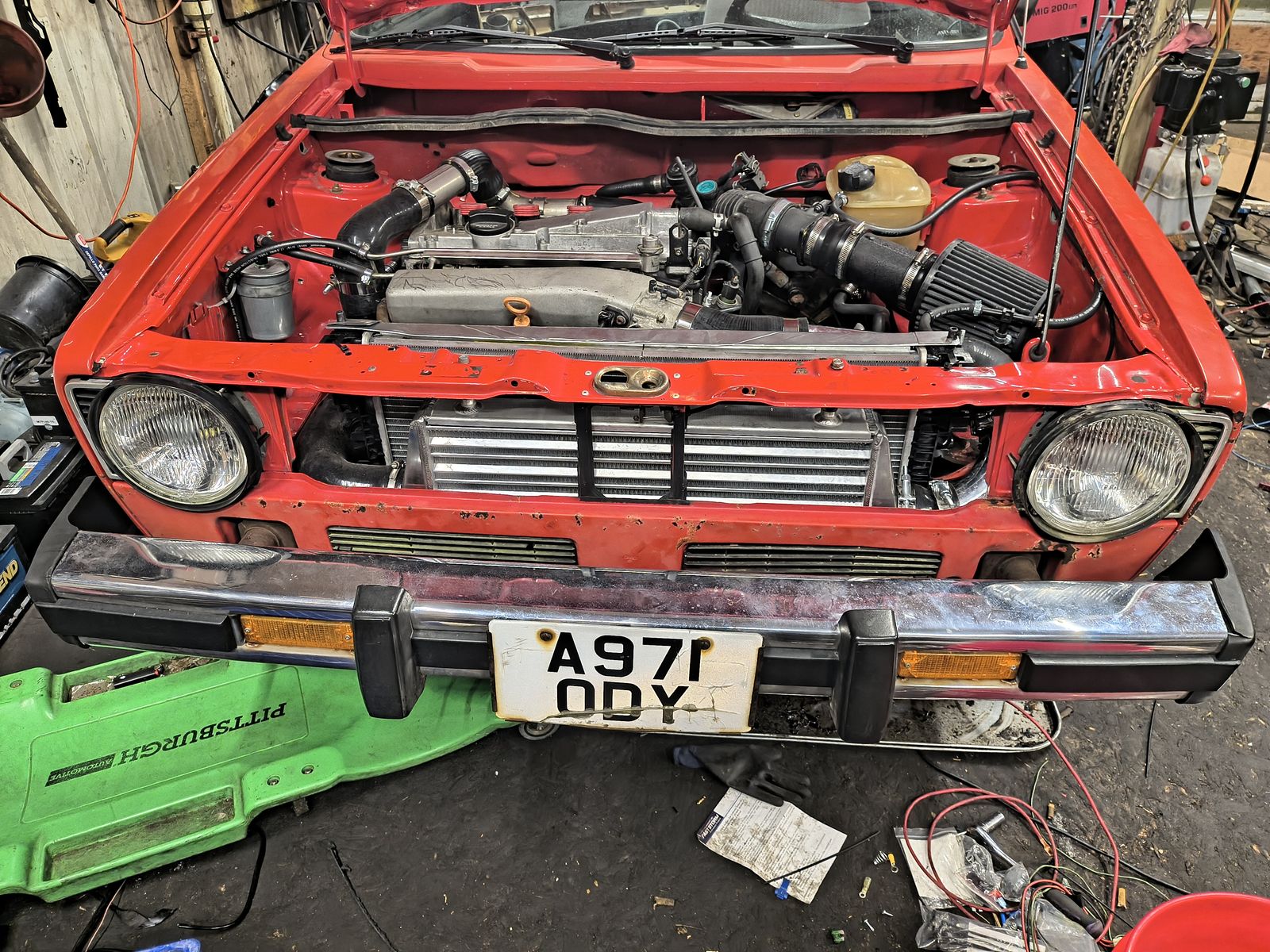 A row of MK1 through MK4 VWs at a meet, hoods up — the cars A R Engine works on